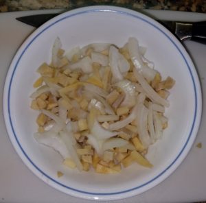 sliced onion and chopped ginger for mango chicken
